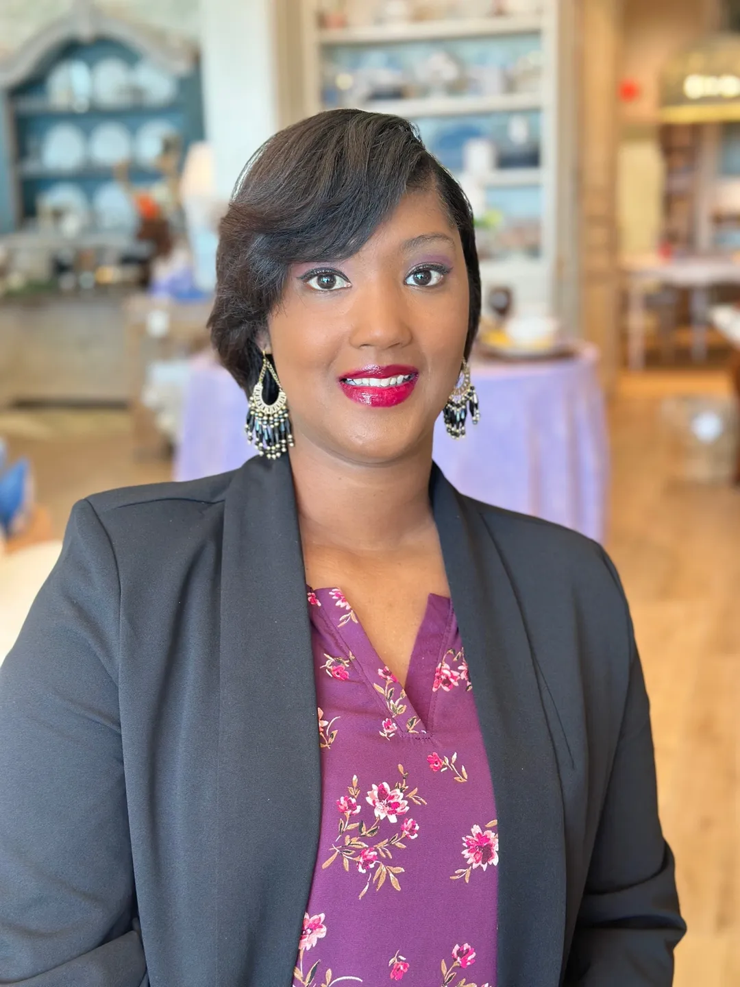 A woman in a purple shirt and black jacket