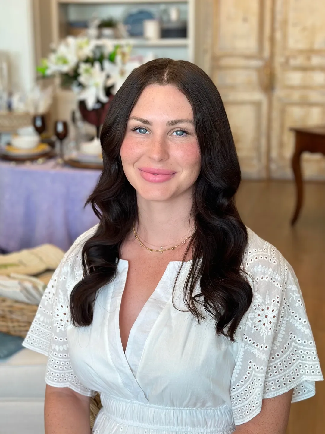 A woman with long black hair wearing white shirt.