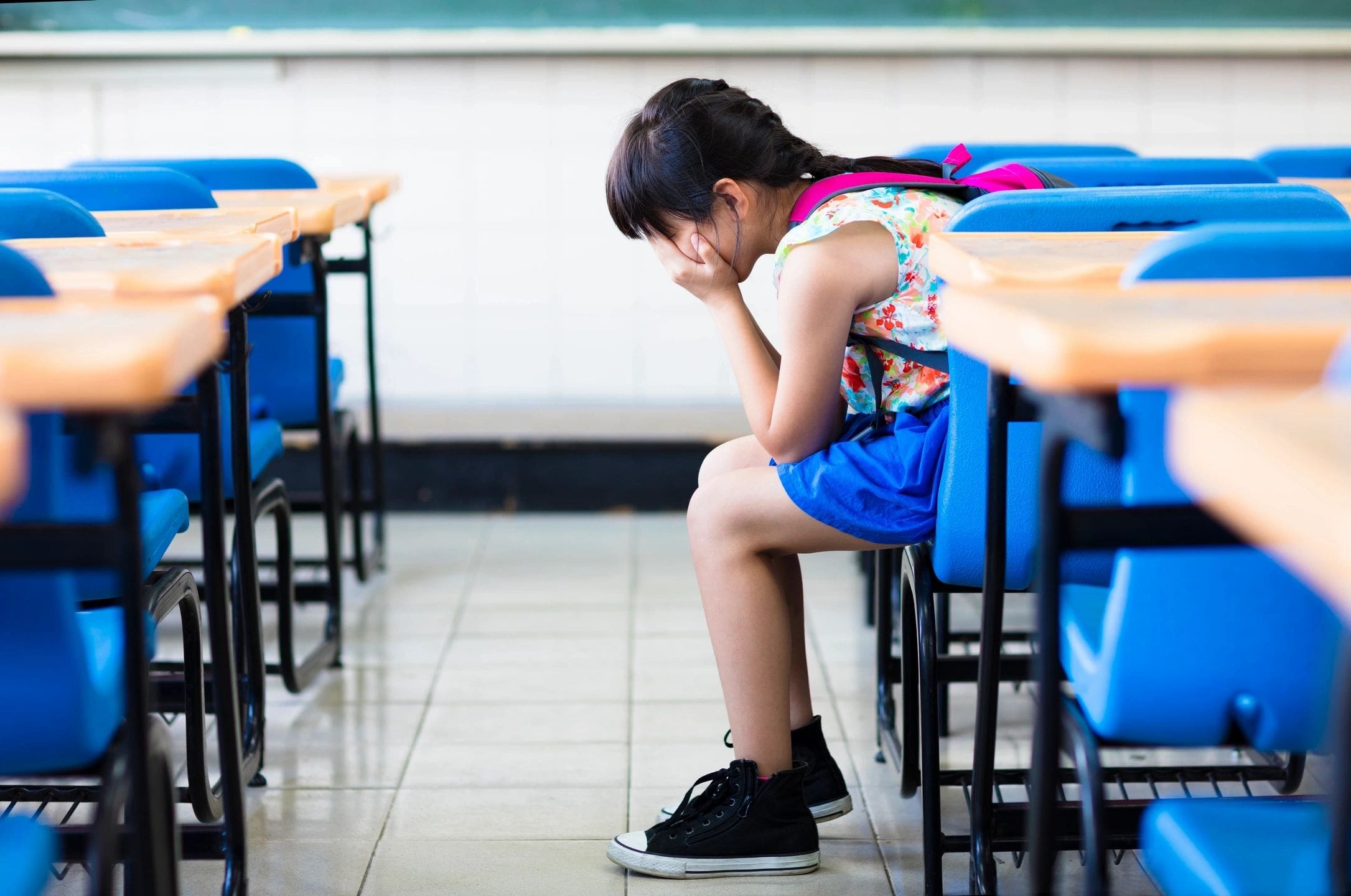 A girl sitting at her desk in the middle of an exam.