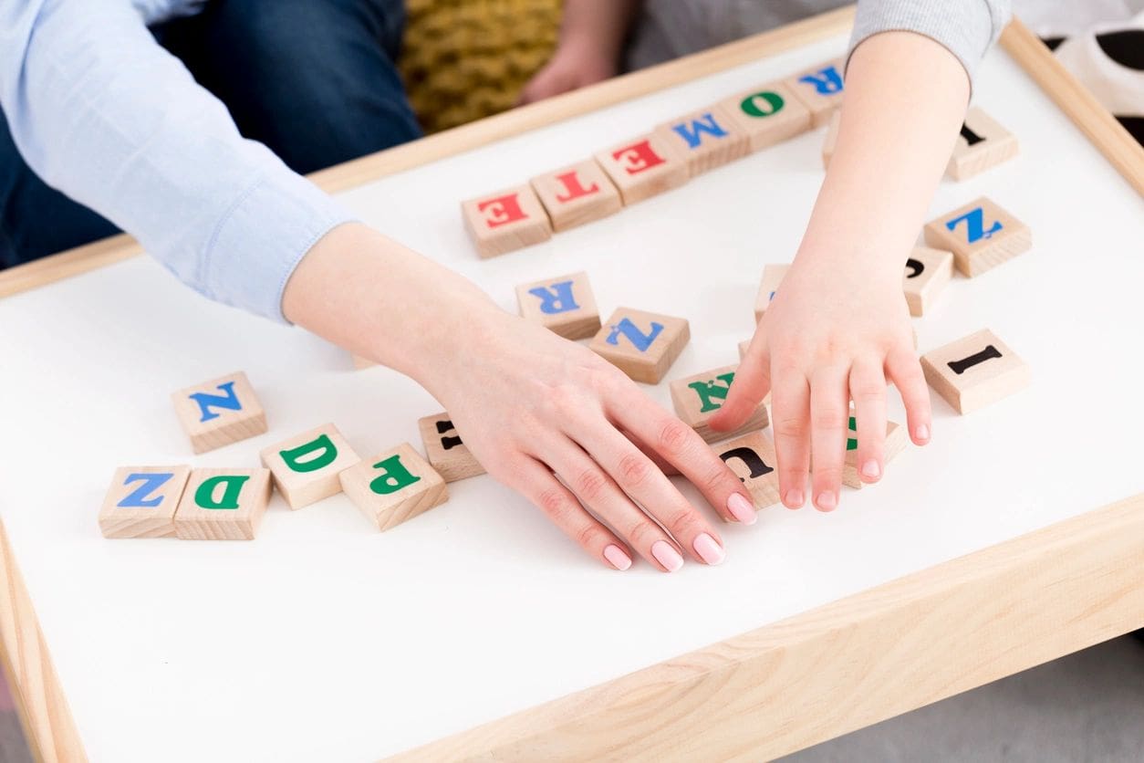 Two people are playing a game with blocks.