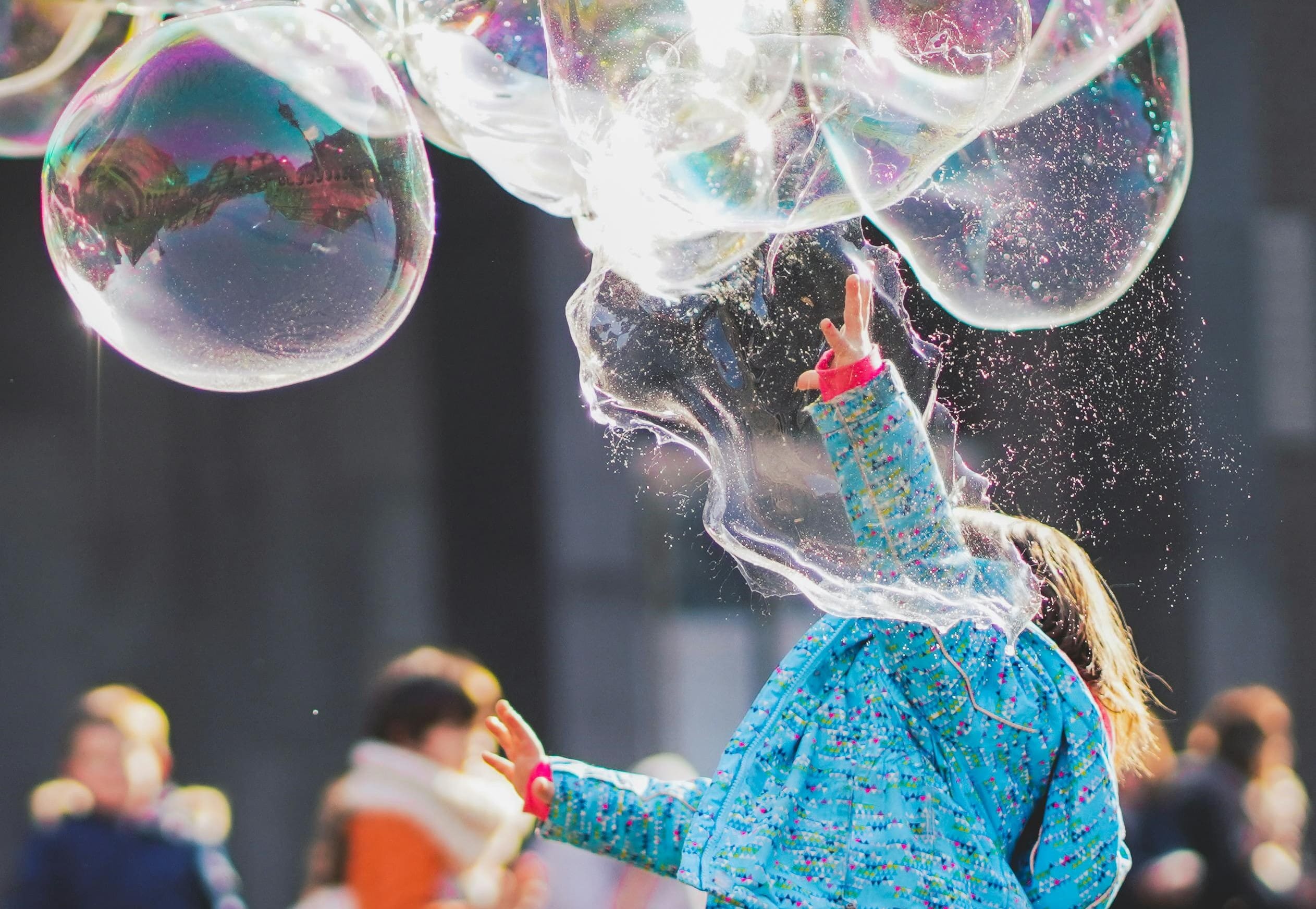 A person in blue dress and bubbles